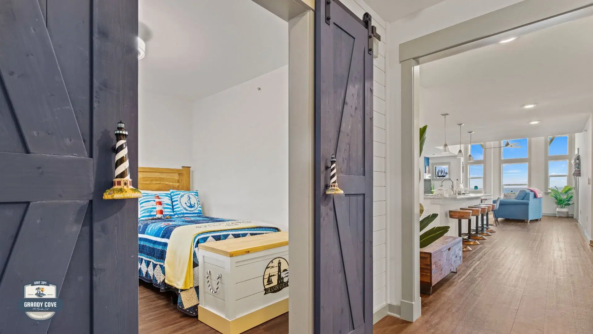 Grandy Cove barn doors open showing third bedroom and living area
