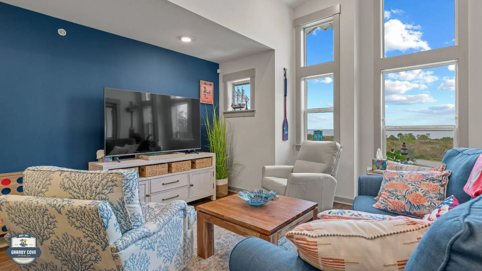 Grandy Cove living room with blue sofa and Currituck Sound views
