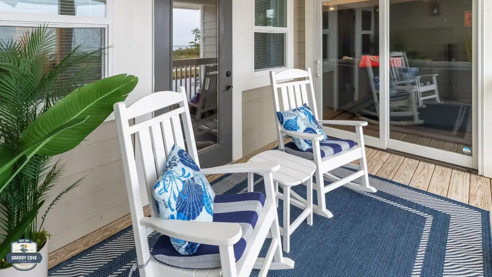Grandy Cove private porch with white rocking chairs